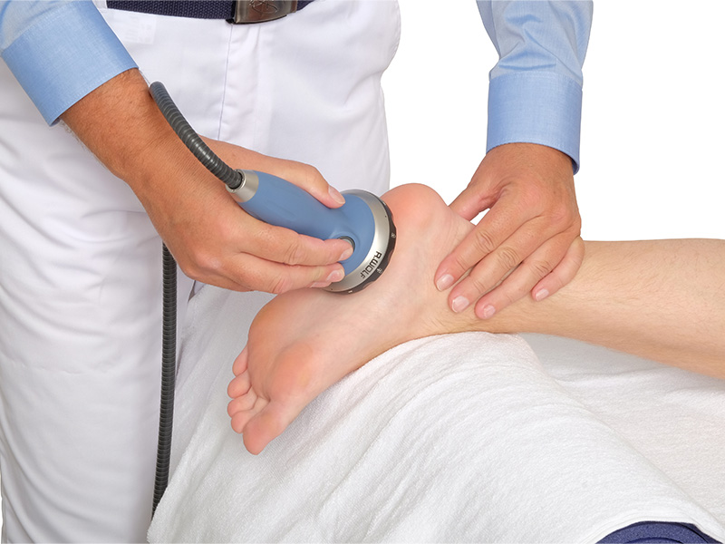 Patient getting shockwave therapy on their foot